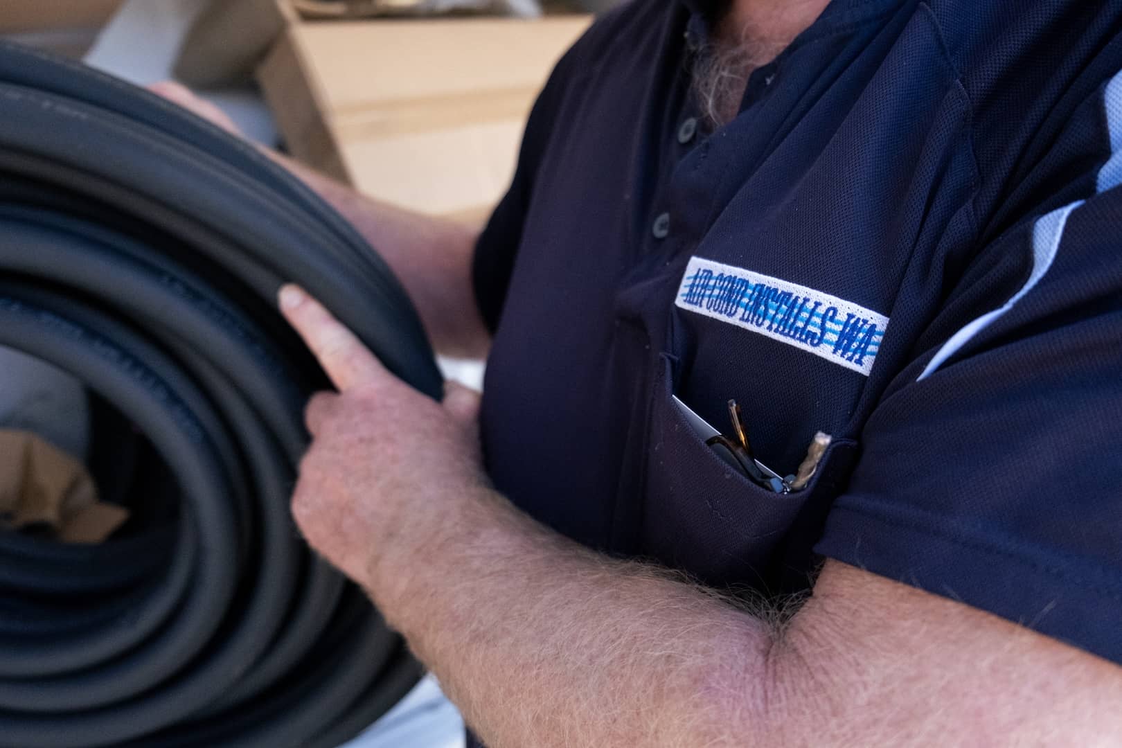 air cond installs wa technician holding role of rubber