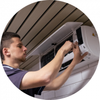 guy fixing an air conditioner on wall